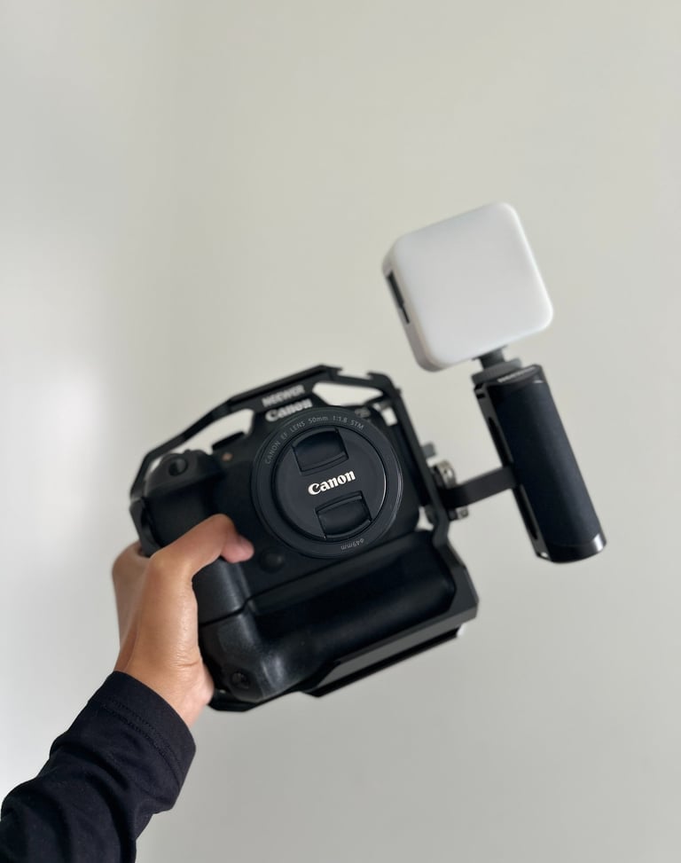 a person holding a camera and a camera
