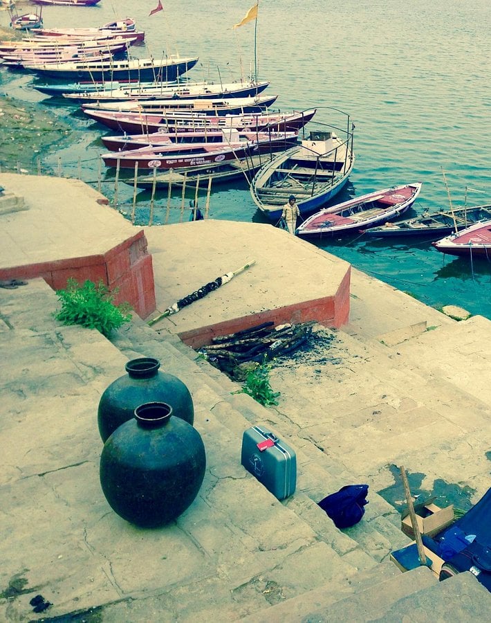 a group of boats parked on the shore of a lake