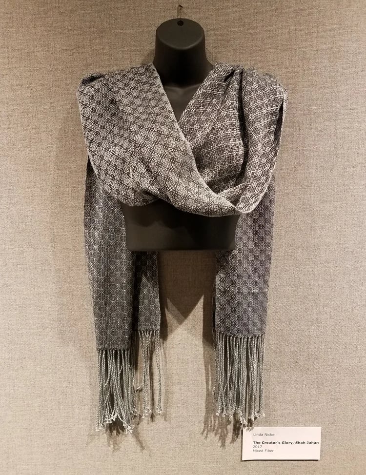 A grey colored hand-woven shawl on display at the Harm Museum of Art.