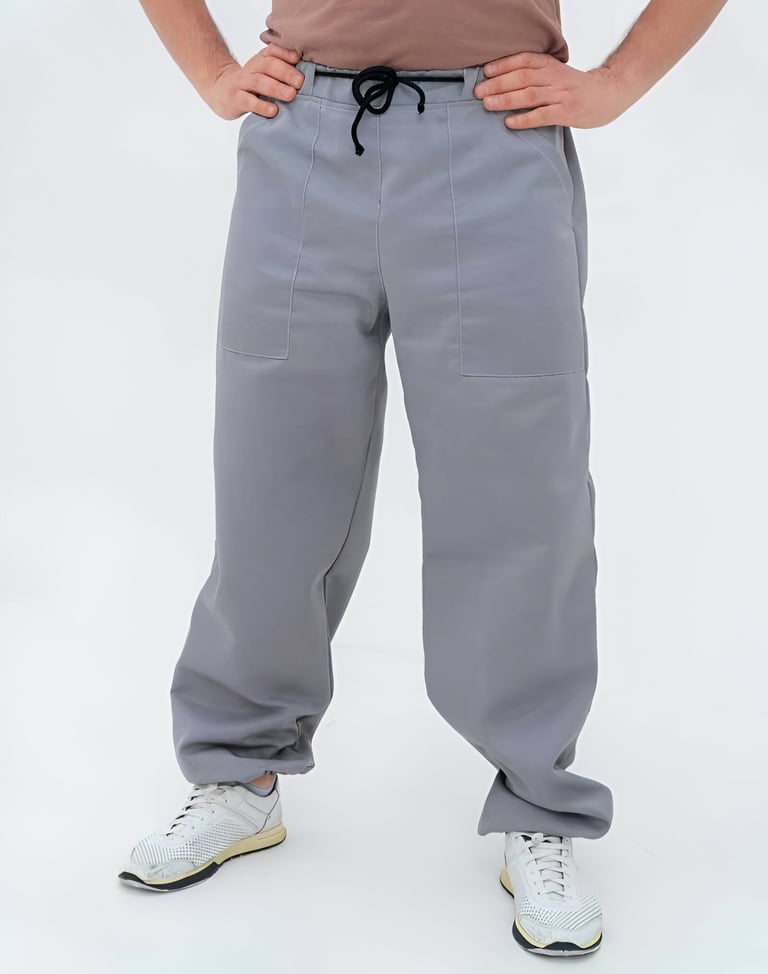 a man in a brown shirt and grey bee pants