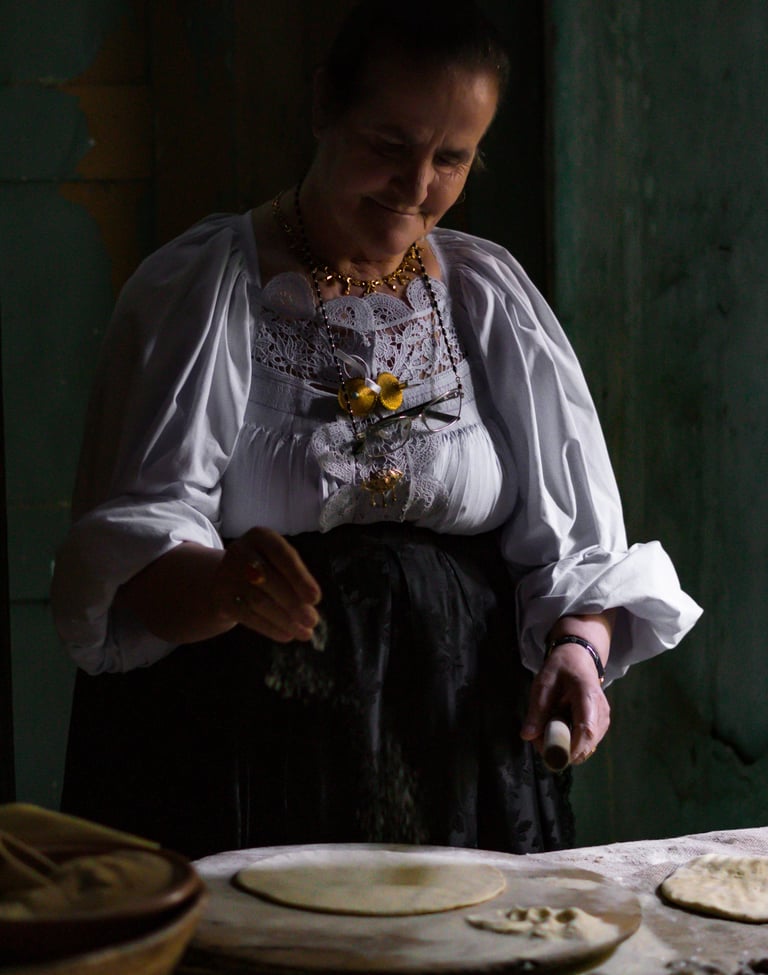 Woman in traditional Oliena dress making pane carasau, Sardinia