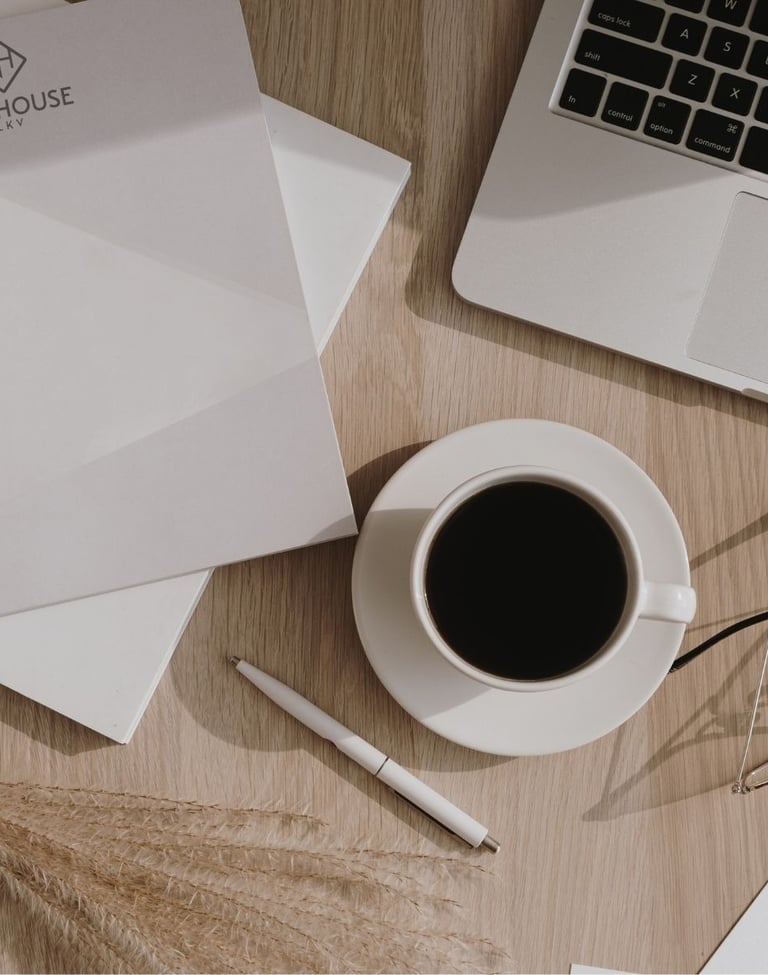 a laptop computer and a cup of coffee on a table
