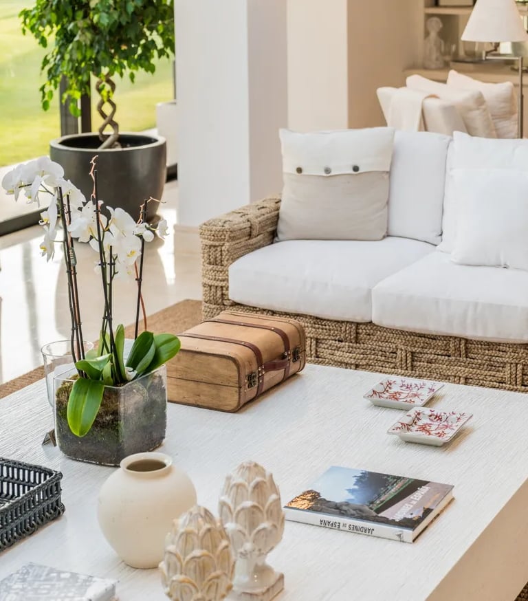 Natural-textured living area with woven sofa and garden views at Villa El Olivo, Marbella