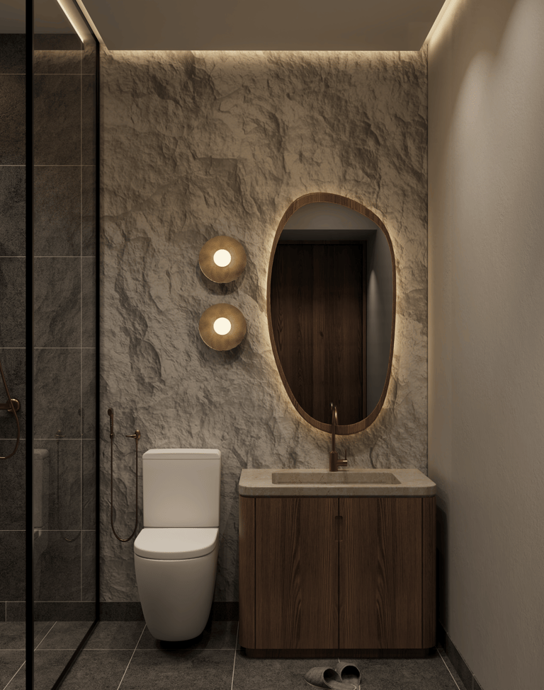 Modern bathroom with stone wall, floating wood vanity, oval mirror, and concealed ambient lighting.