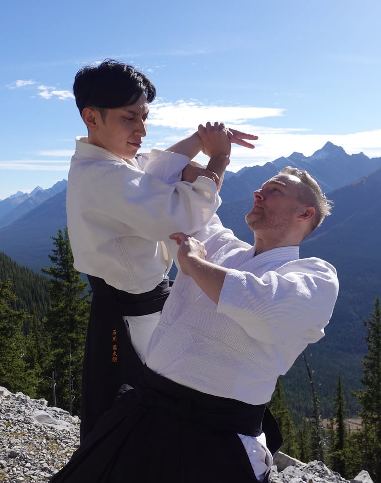 Rentaro Ishikawa performs an Aikido arm-lock throw during class in calgary