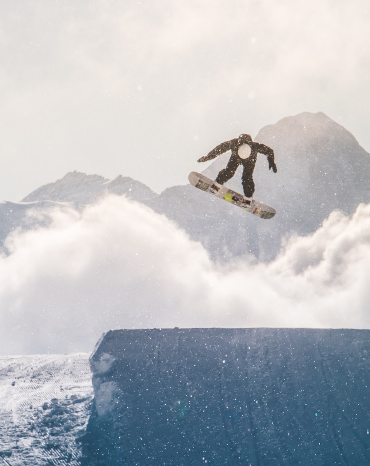 a snowboarder is doing a trick on a ramp