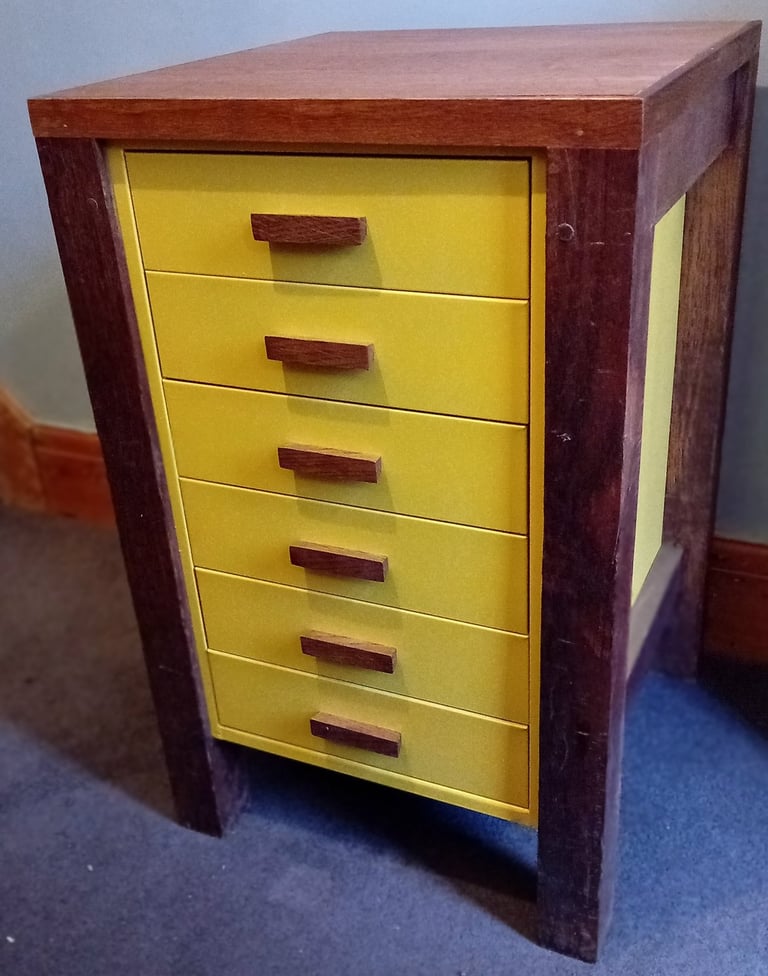 Drawers have been shortened, sprayed bright yellow, given oak handles and mounted in an oak frame