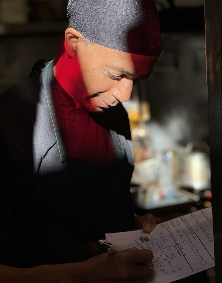 a chef in a restaurant writing a menu