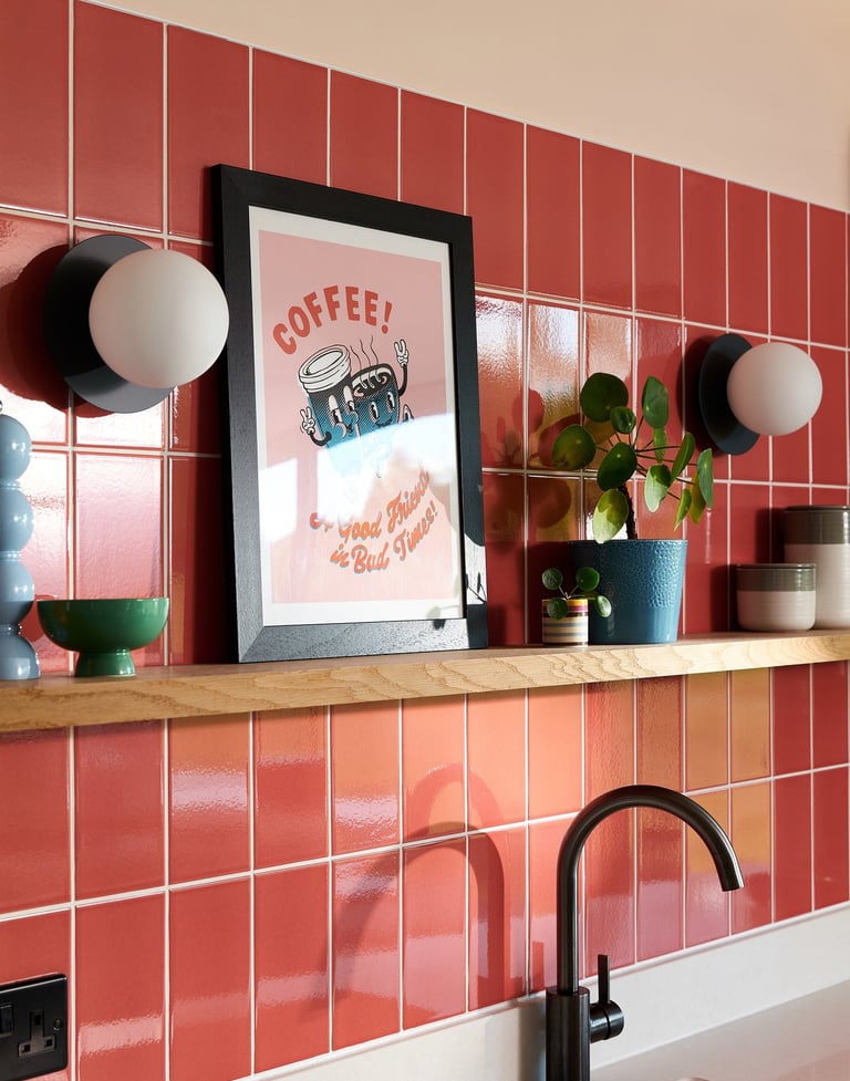 Glossy coral wall tiles with white grout in a modern kitchen splashback, featuring pastel pink