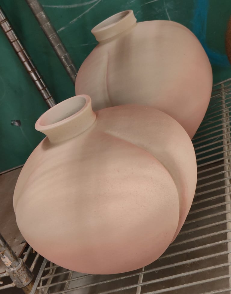large wheel-thrown vases, altered by paddling, spray glazed and waiting for high fire
