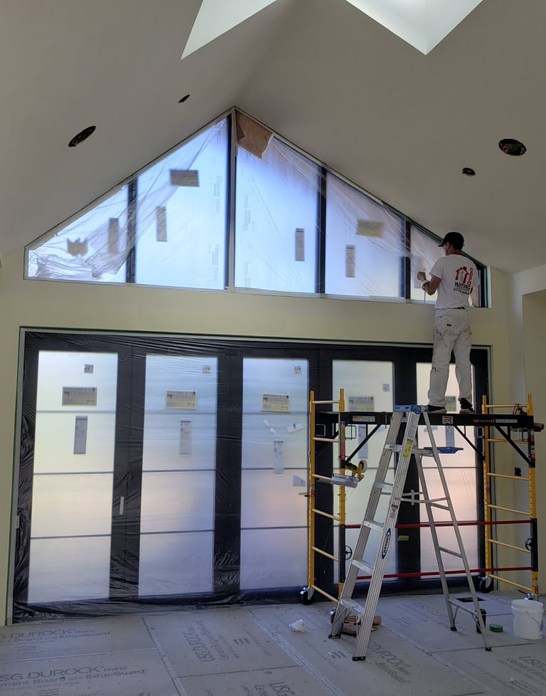 House painter a man standing on a scaffolding with a ladder - Full Interior House Painting
