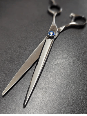 Professional grooming shears being sharpened for dog groomers