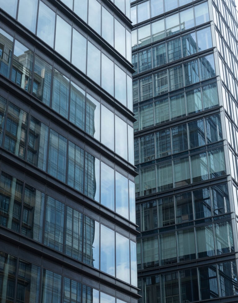 Abstract shot of modern architecture with glass and steel in shades of sky blue and navy blue, reflecting clarity and structural integrity.