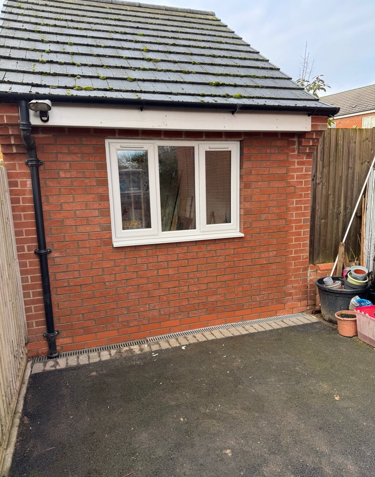 Front view of converted garage showing new window and brickwork