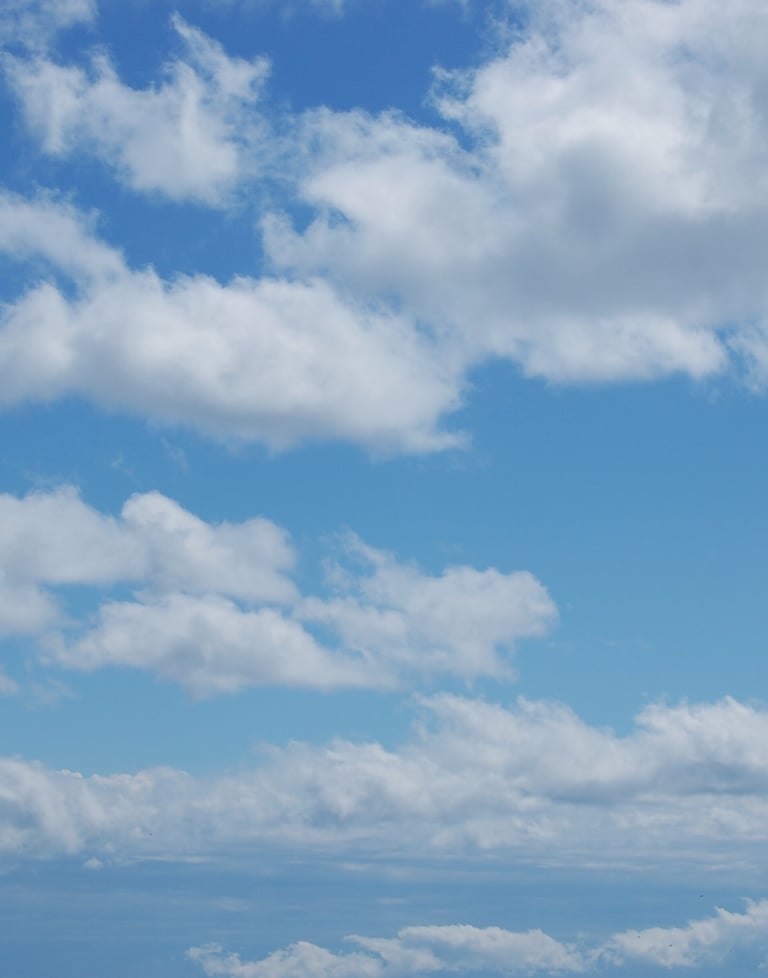 Beautiful baby blue sky with big white cumulus clouds