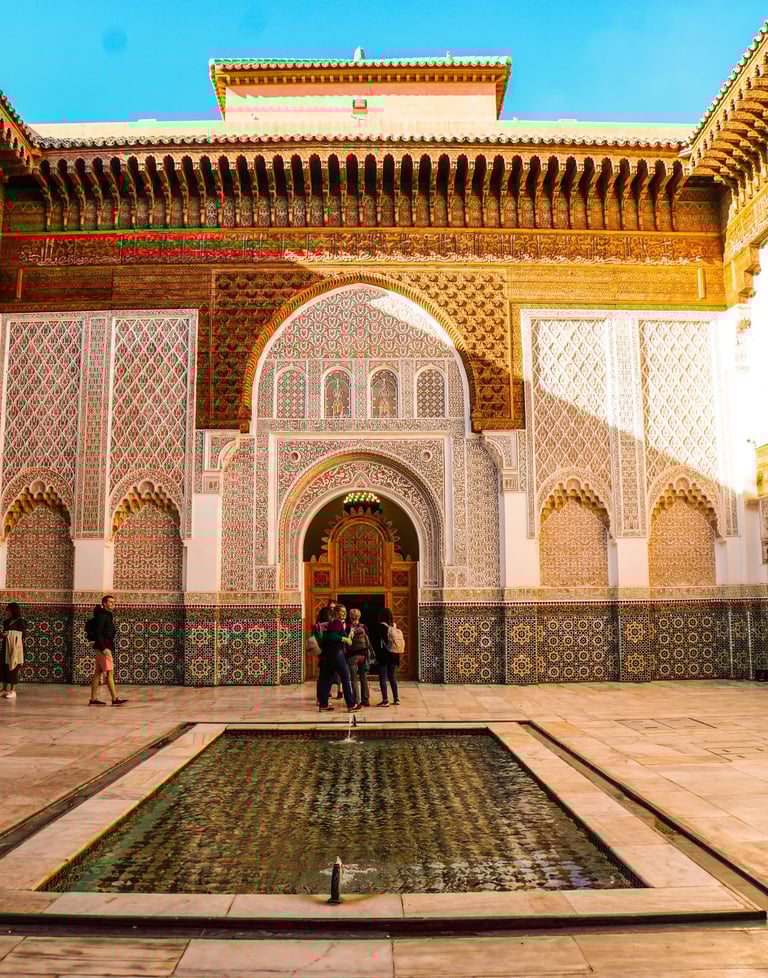 Traditional Moroccan riad courtyard with mosaic tiles and Islamic architecture