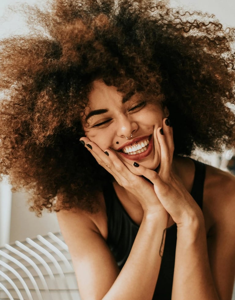 a woman with a curly afro hairs and a black dress