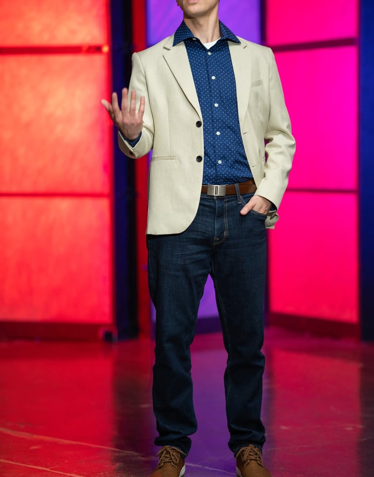 Remy stands on stage speaking