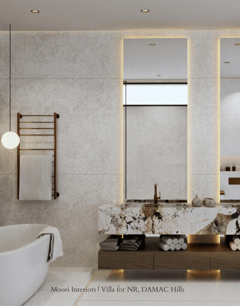 Bathroom with a Calacata Gold marble sink, a freestanding tub, and a heated towel rack.
