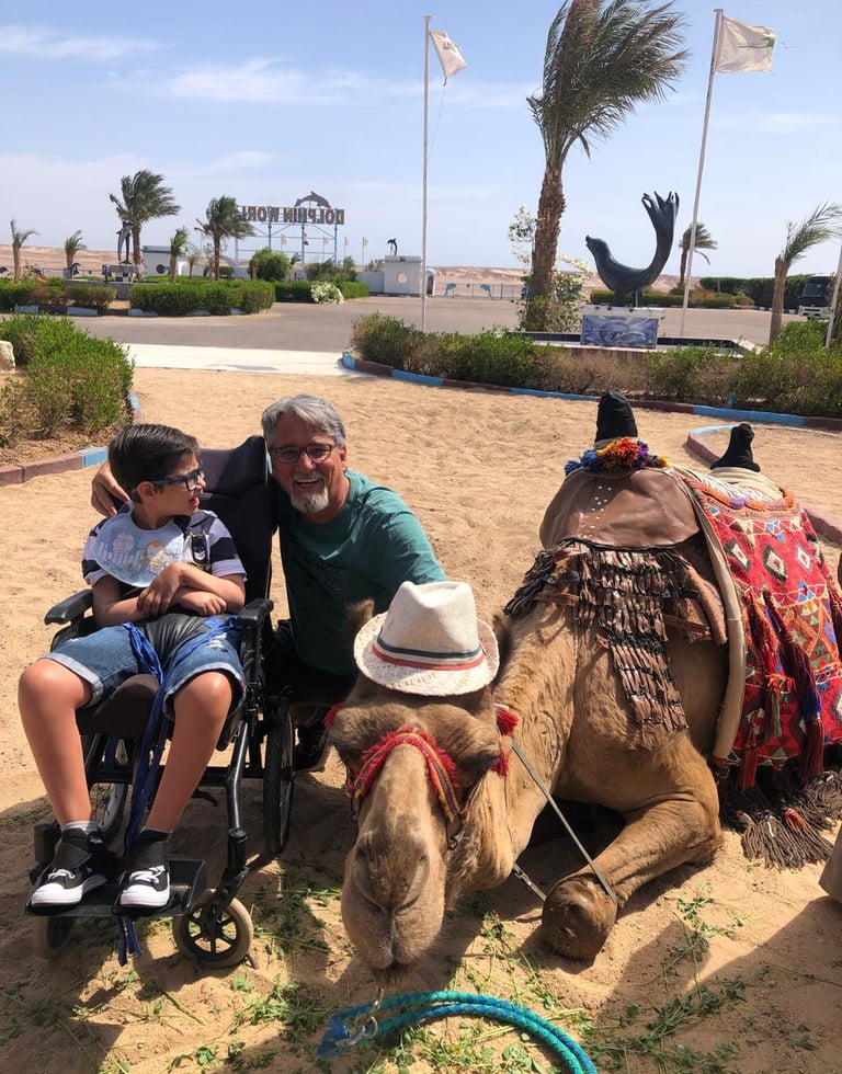 Photo of Benjamin next to a Camel in Egypt