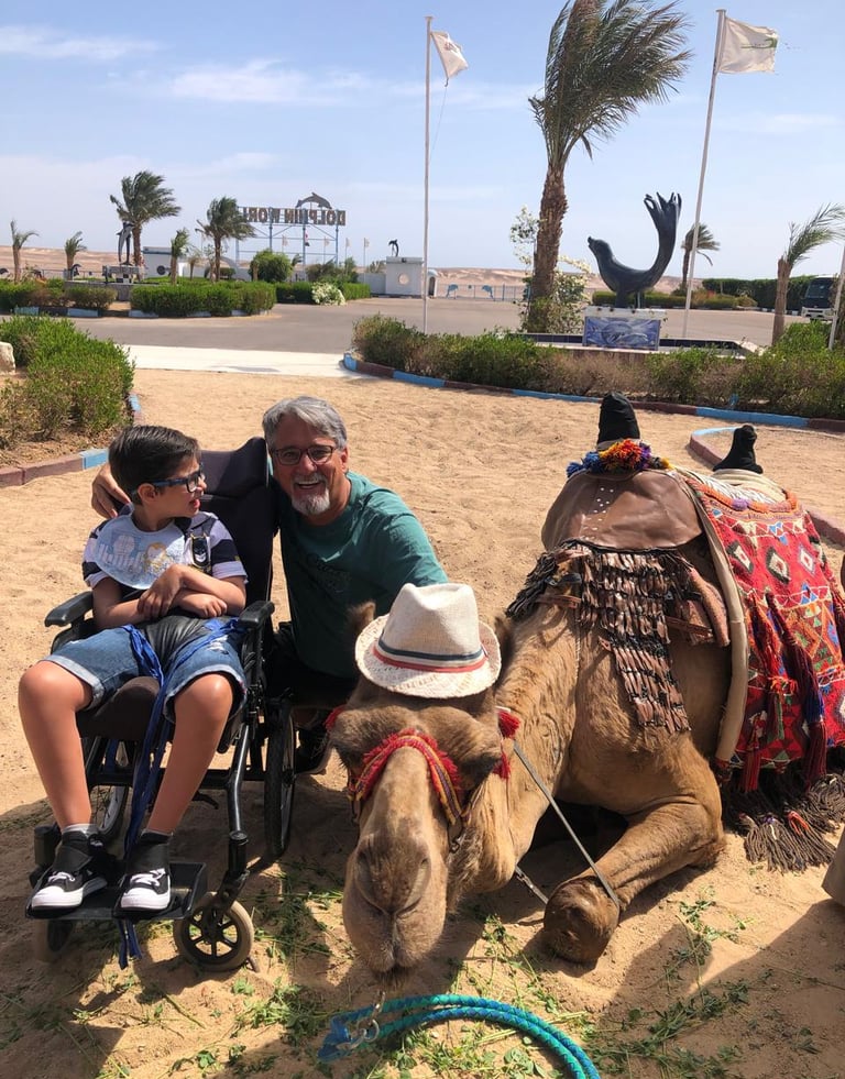 Photo of Benjamin next to a Camel in Egypt