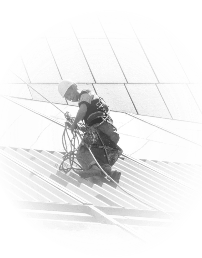 Professional construction worker in safety gear performing high-altitude building maintenance.