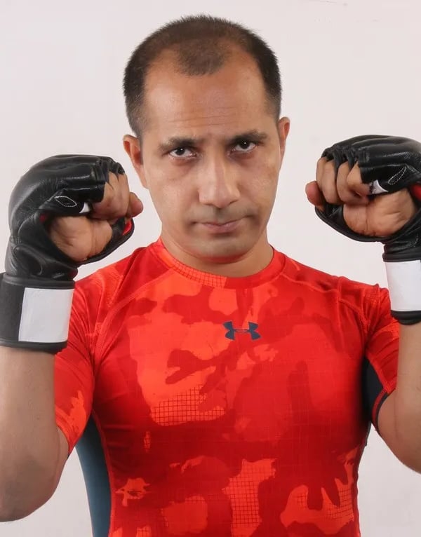 a man in a red shirt and black gloves