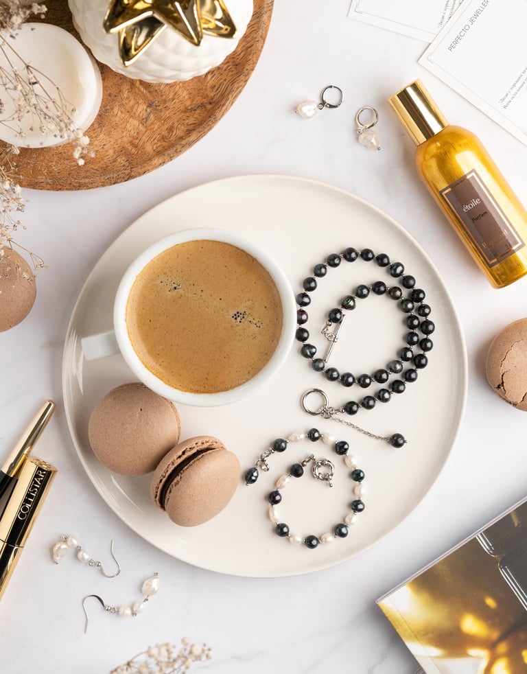a cup of coffee and a rosary on a plate