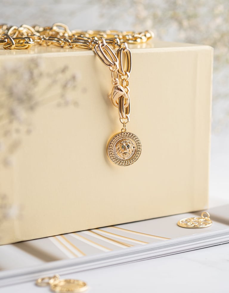 a gold chain link bracelet with a gold chain link bracelet