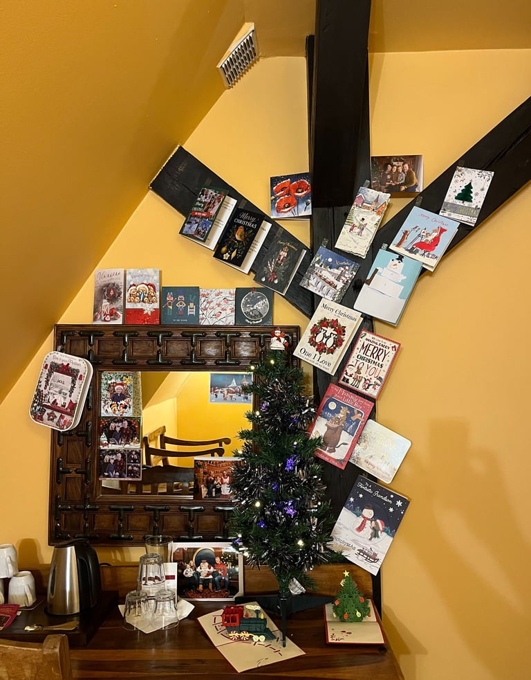 Christmas cards and tree up in hotel room in Ryn caste