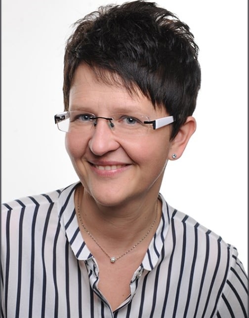 a woman with glasses and a necklace on her neck