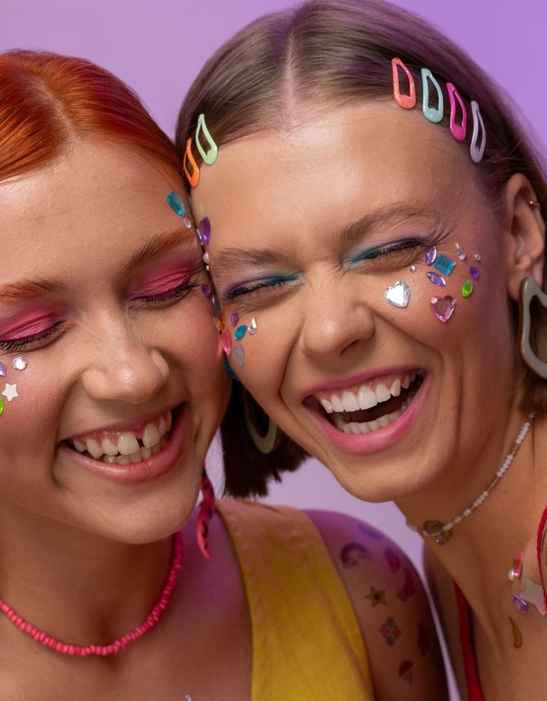 two women with colorful makeup and face paint