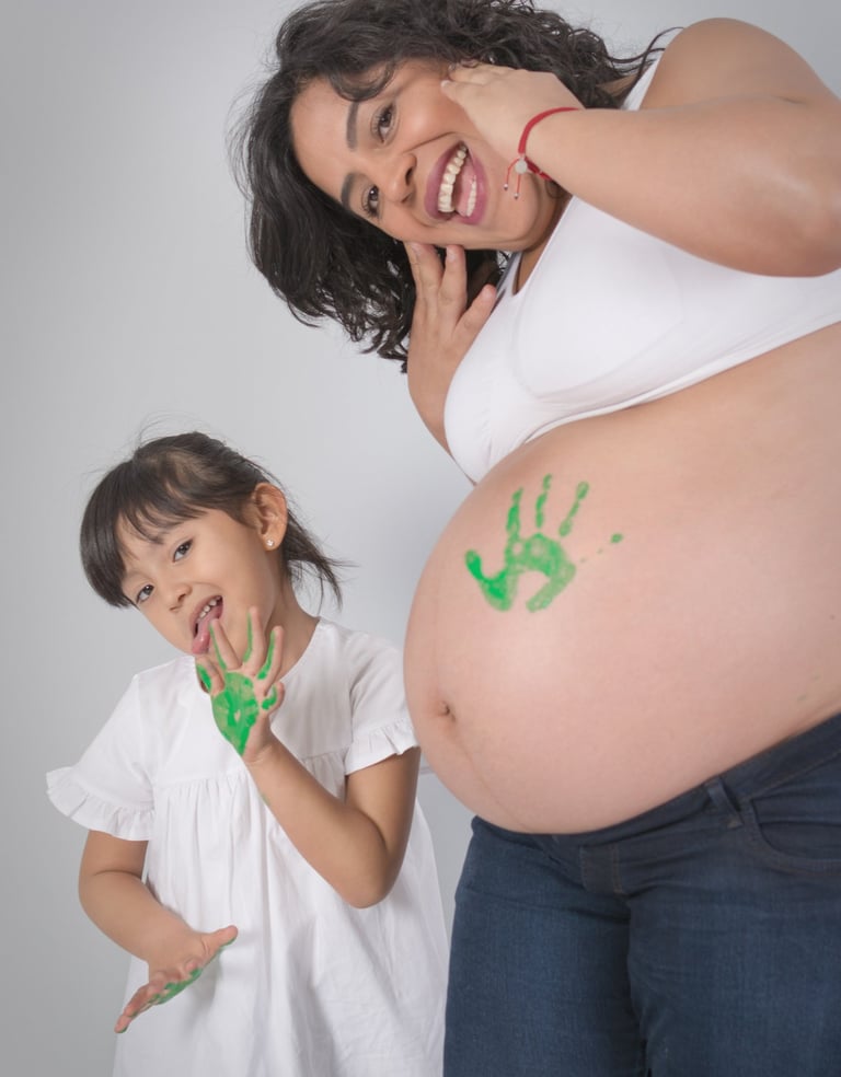 a pregnant woman with a baby bump bumping her belly
