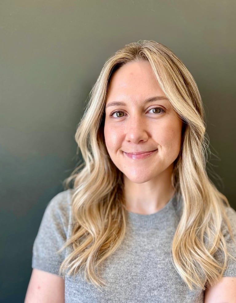a woman with blonde hair and a gray shirt