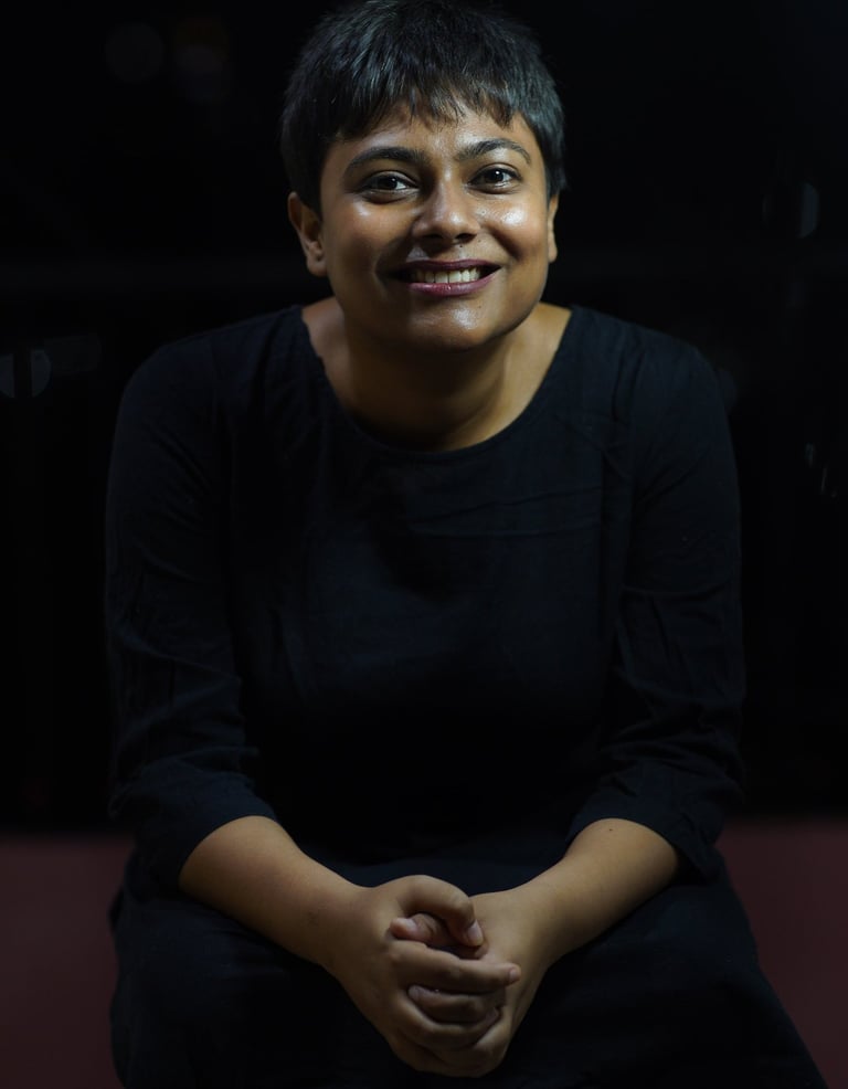 This is an image of the therapist. With a black background and clothing, a wide welcoming smile