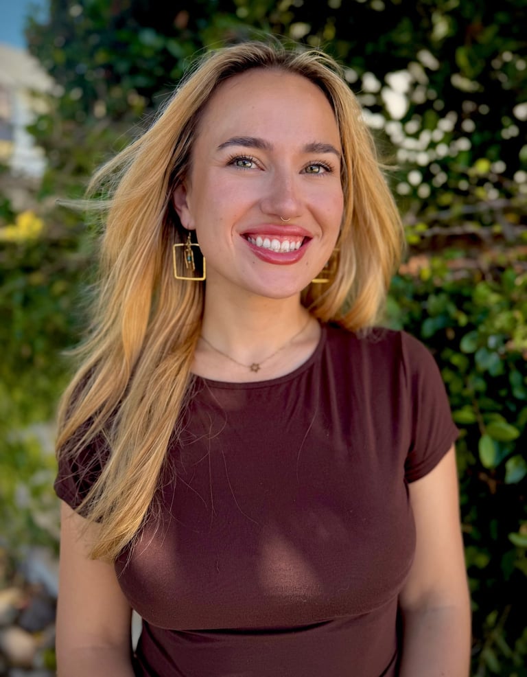owner of business headshot in front of greenery