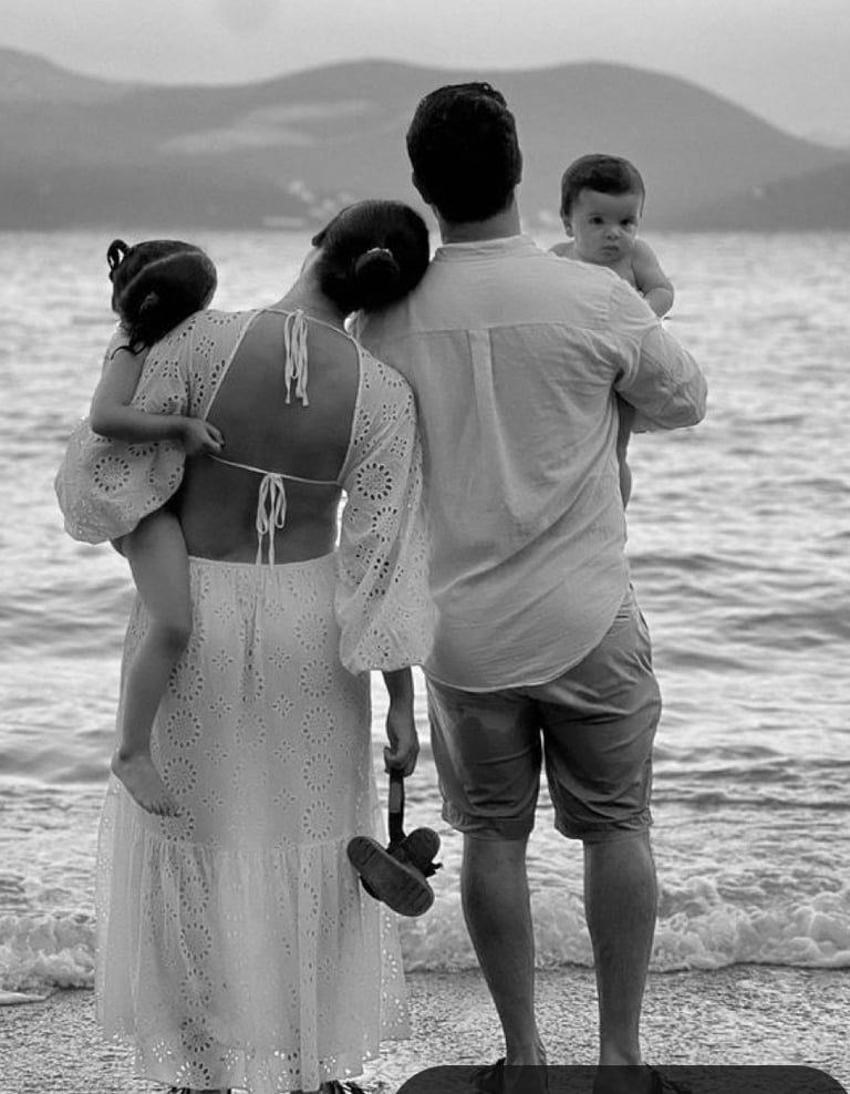 A couple doing couples therapy on the beach with their kids at hand