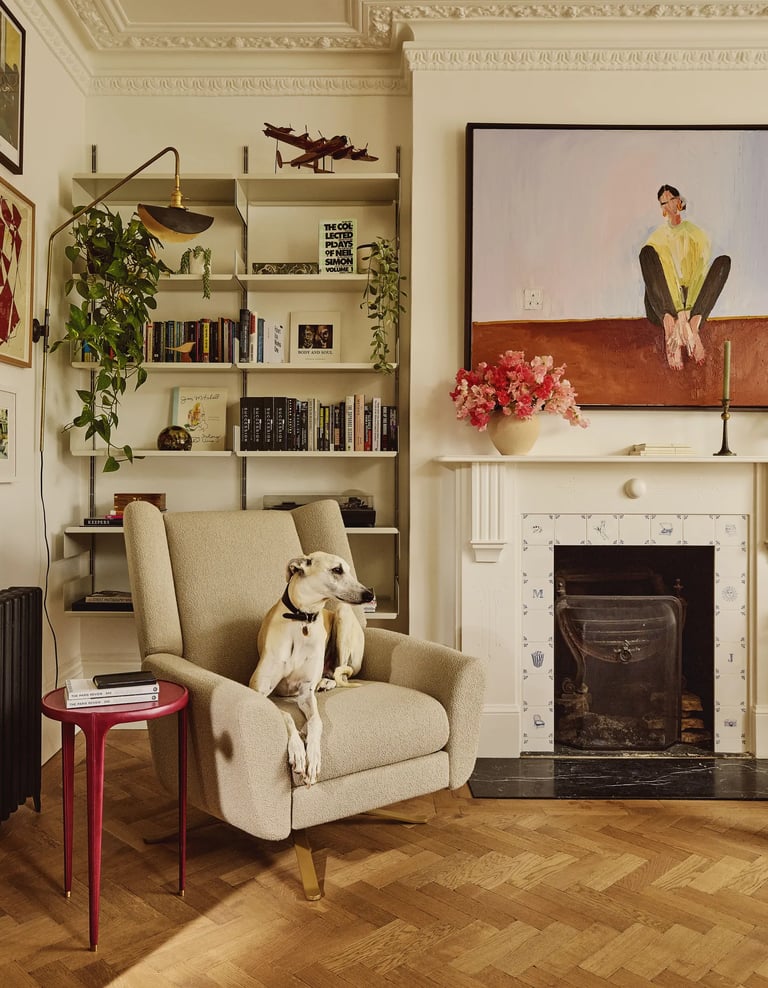 Michelle Dockery’s dog Alfie sitting on armchair in private home.