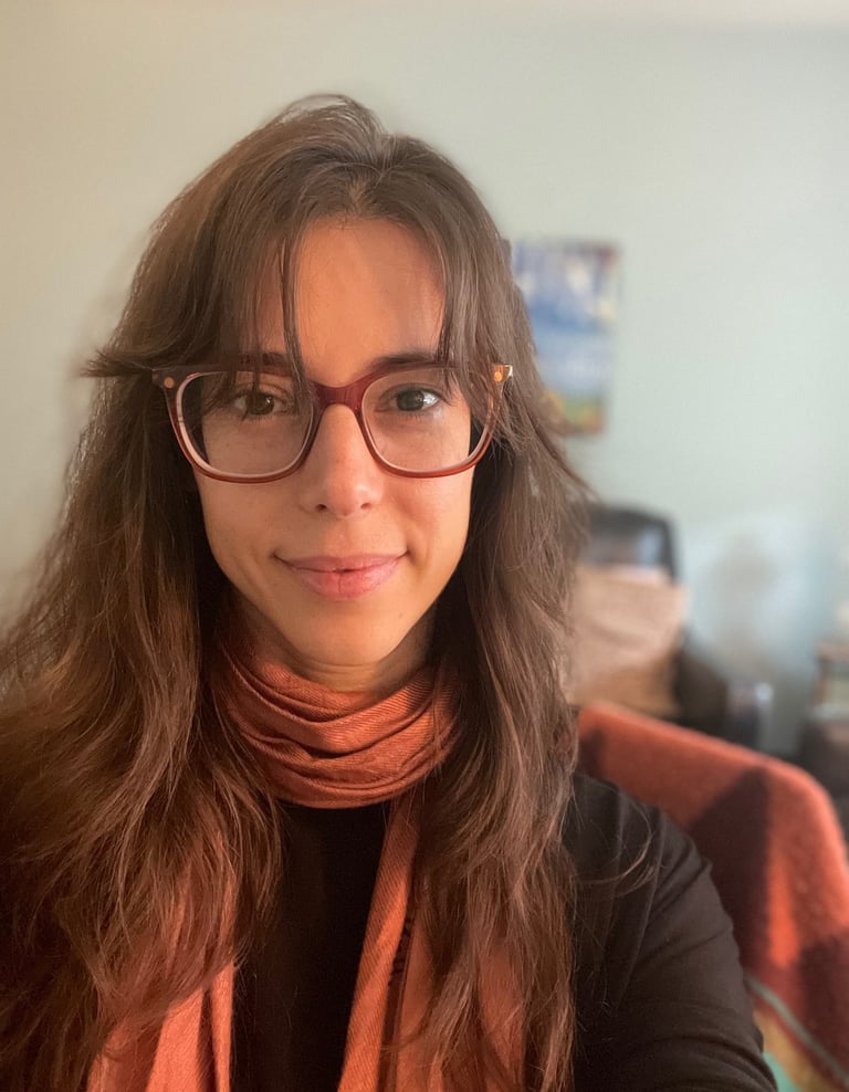 a woman with glasses and a scarf around her neck