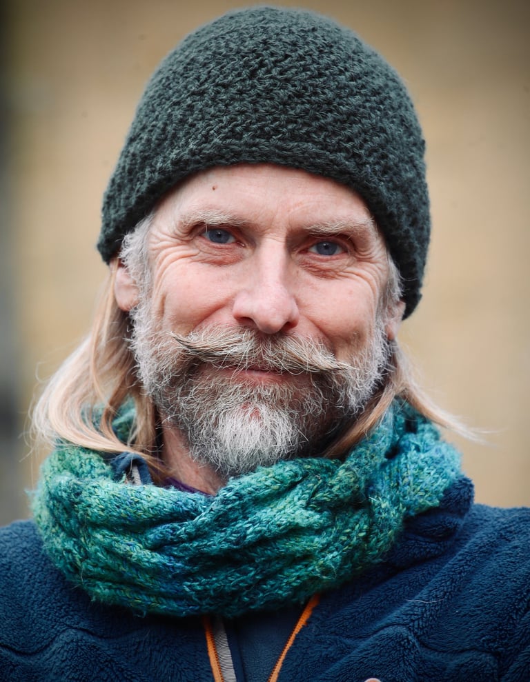 Portrait of narrative consultant, coach and facilitator, Dominic Weston, in woolly hat and scarf