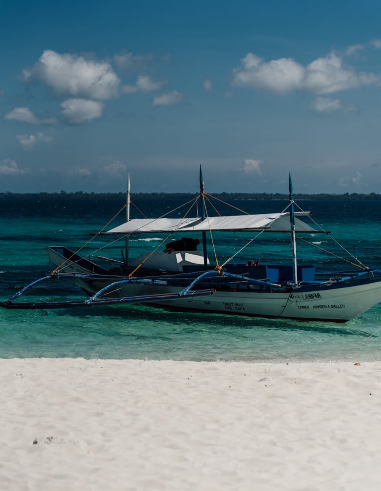 a boat on the beach with a boat in the water