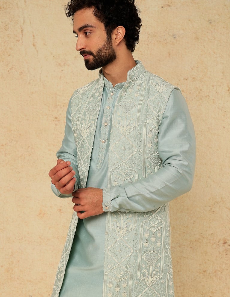 a man in a blue and white suit and a beardless man in a blue