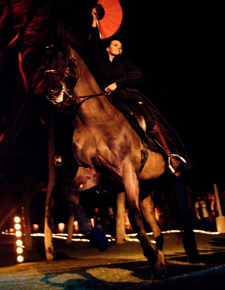 Bride on horseback with red fan at night wedding show