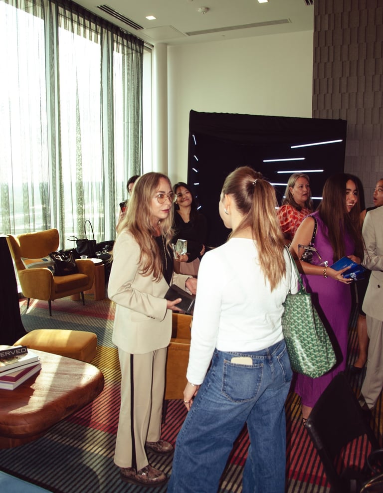 a group of people standing around a table