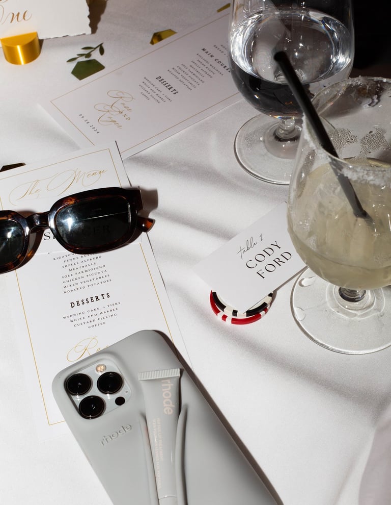 a wine glass and sunglasses on a table
