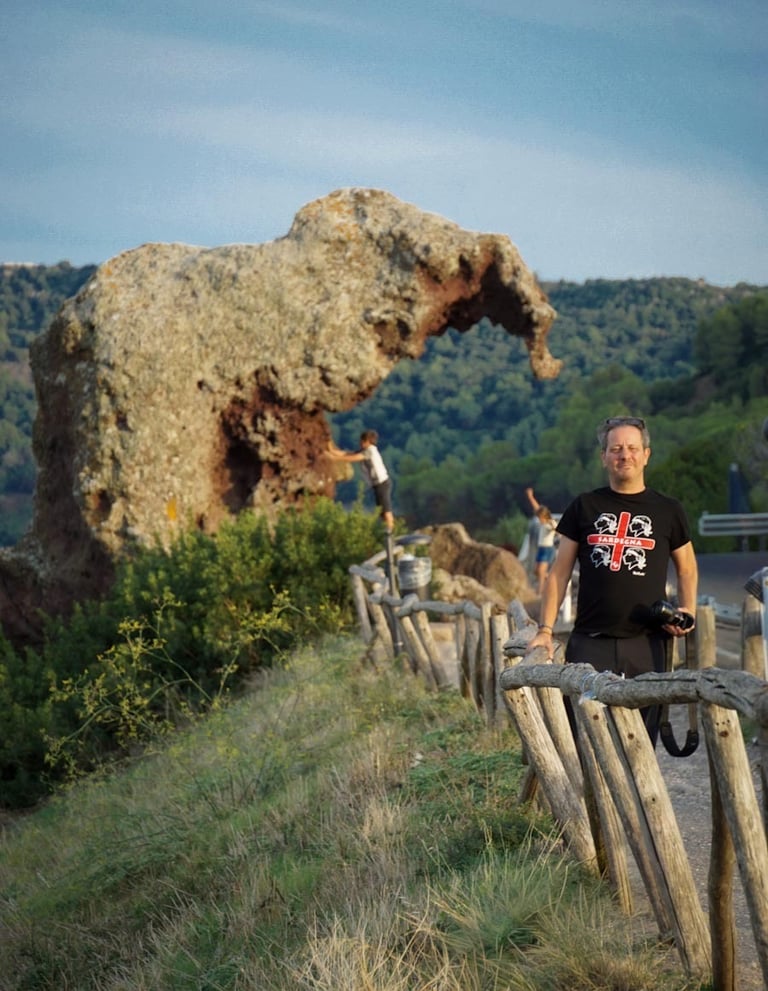 Franco Prisco at Roccia dell’Elefante in Castelsardo, Sardinia, with UNESCO-listed domus de janas.