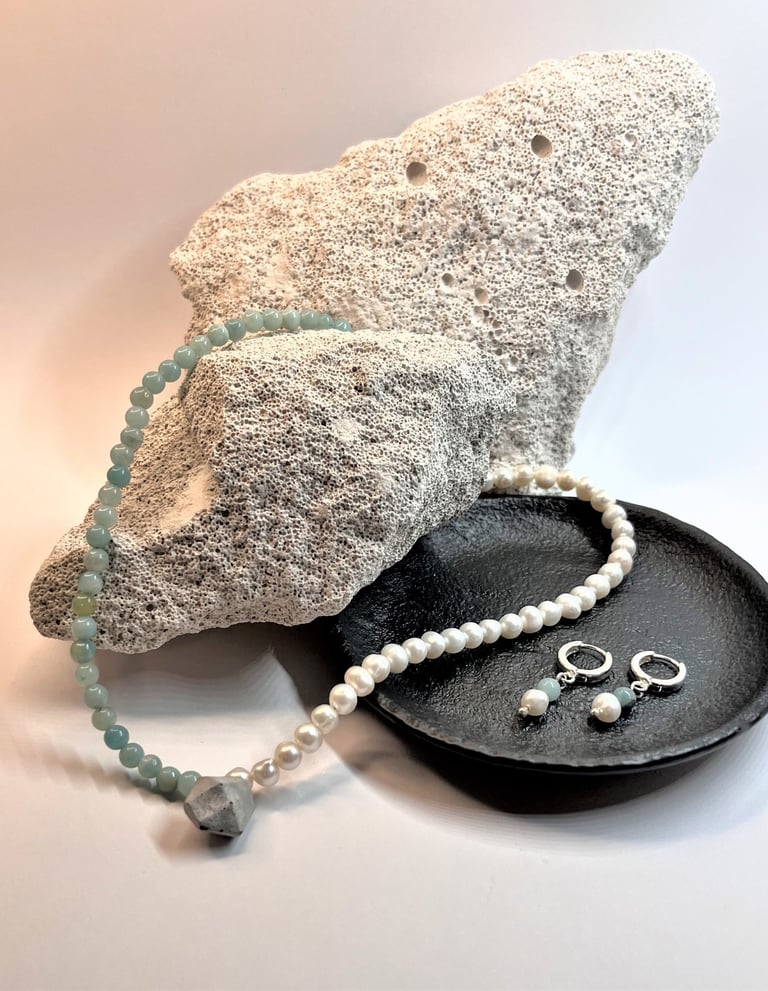 a necklace with a pearl necklace and a pearl necklace