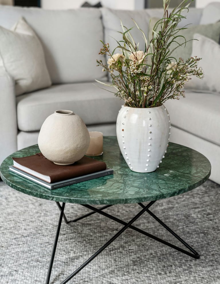 Neutral living room with large woven area rug under sofa and a coffee table