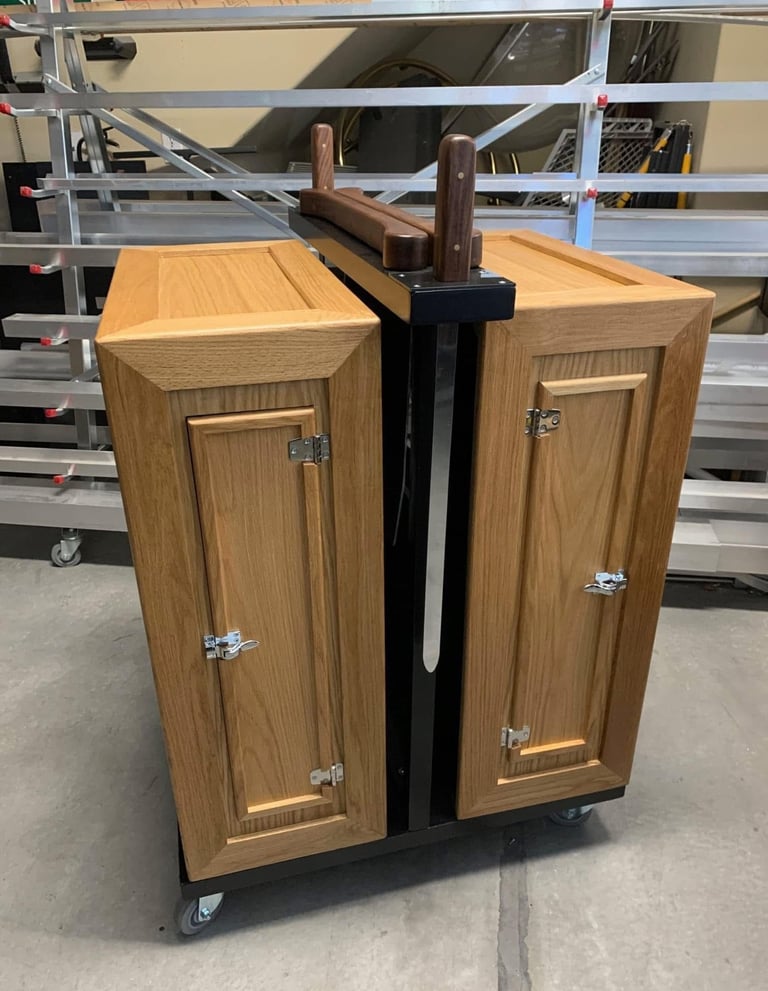 Professional magic stage prop for a sword cabinet illusion made of oak wood on a rolling metal frame.