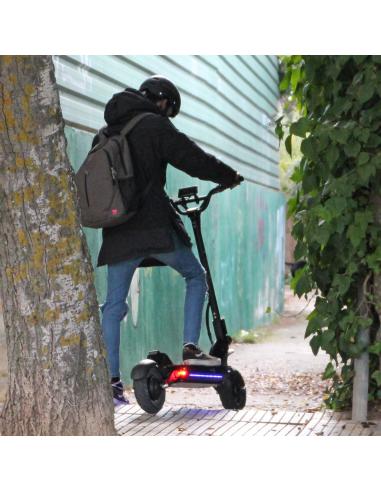 a person riding a scooter on a sidewalk